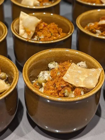 For catering events, I often serve tasting portions of my classic dishes, like this Kanji Payar. These small bowls allow guests to sample a variety of flavors without getting too full, making for a great start to a multi-course meal.