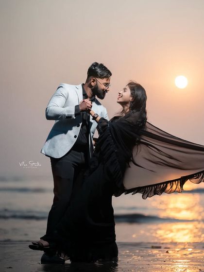 A dramatic and beautiful sunset dance on the beach. The flowing saree and the golden sun create a cinematic moment that is both elegant and full of motion.
