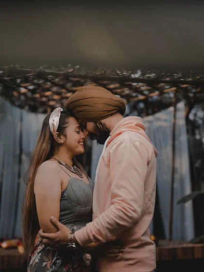 An intimate and moody shot of Avneet and Lavleen at the Bali set. The soft lighting and their close embrace create a deeply romantic and atmospheric portrait.