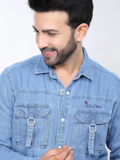 This image showcases a light-wash denim shirt with utility pockets. The clean background and clear view of the details are ideal for an e-commerce product page.