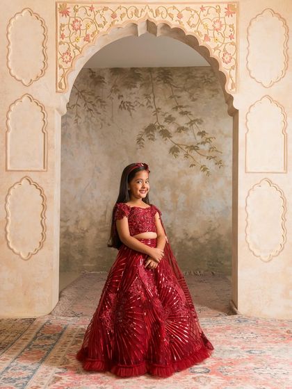 A joyful pose in our custom red lehenga, highlighting its twirl worthy skirt and comfortable fit for kids.