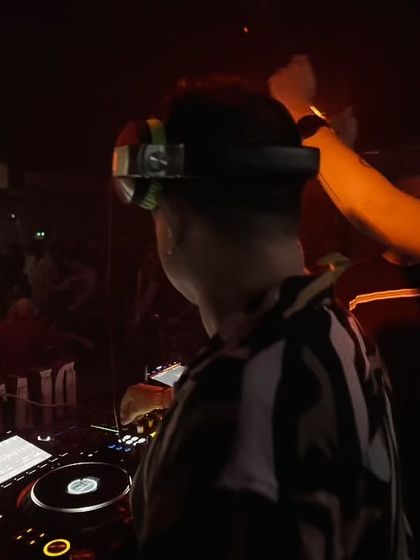 A close-up moment during a collaborative set. The focus and communication between DJs are key to a successful B2B performance.