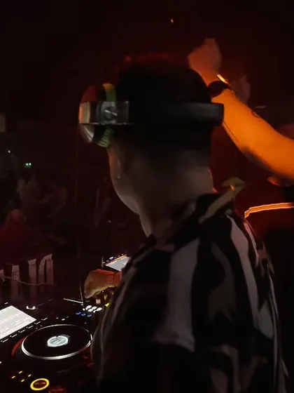 A close-up moment during a collaborative set. The focus and communication between DJs are key to a successful B2B performance.