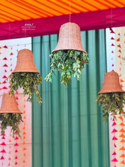 A close-up of the unique hanging planters, made from woven baskets and filled with lush greenery.
