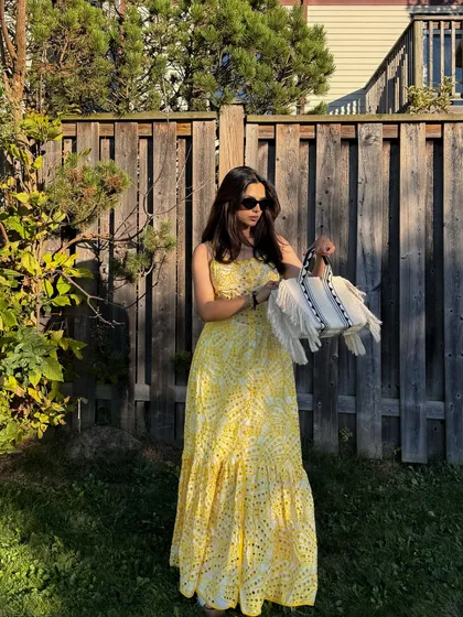 A shot that focuses on the movement of the dress and the stylish handbag.