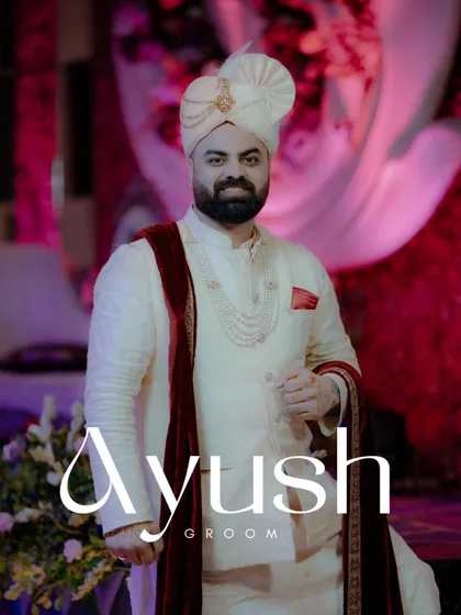 A classic solo portrait of the groom, Ayush, looking dapper in his ivory sherwani and red velvet stole.