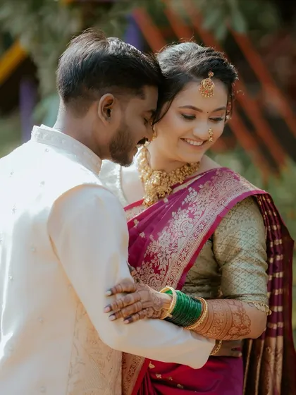 The final look is complete when I see the joy between the couple. This candid moment captures the bride's radiant Maharashtrian look and the happiness of their special day.