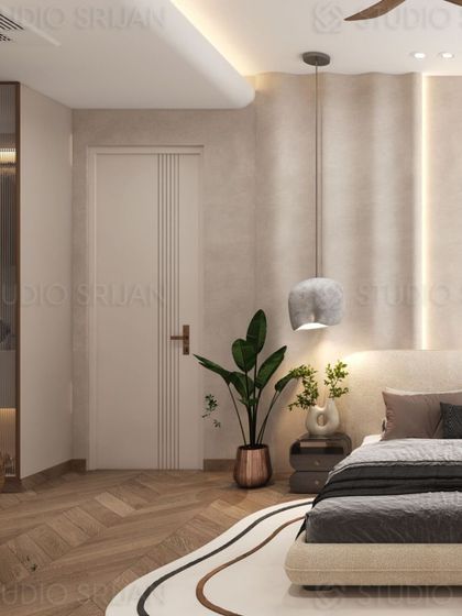 The design of this bedroom incorporates a soft, textured wall finish and a modern, stone-like pendant light, adding layers of interest to the neutral space.