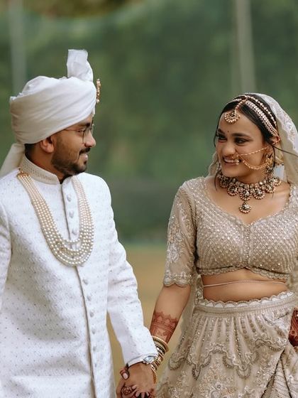 The couple holding hands and sharing a look, a simple yet powerful portrait of their union.