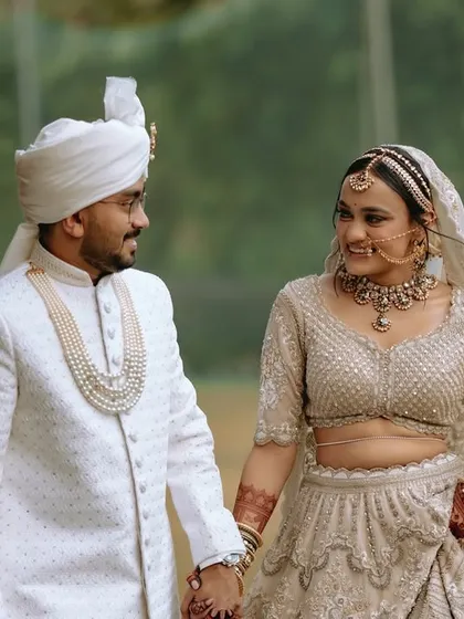 The couple holding hands and sharing a look, a simple yet powerful portrait of their union.