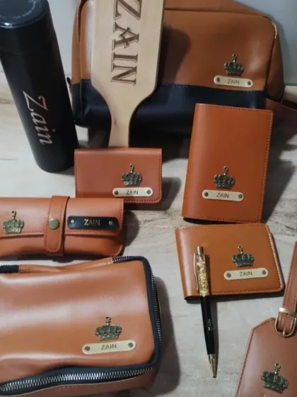 A close-up of the personalized leatherette accessories for actor Zain Imam. Each piece is customized with his name and a crown charm.
