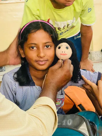 There is no greater joy than seeing a student with the puppet they made themselves. Here, I am helping a young artist at a school workshop in Ayodhya put the final touches on her new friend.