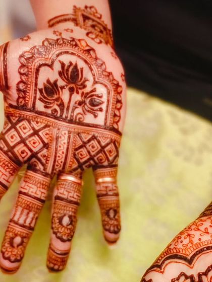 A close-up of the intricate lotus design for Diwali, showing the beautiful detail work on the palm.