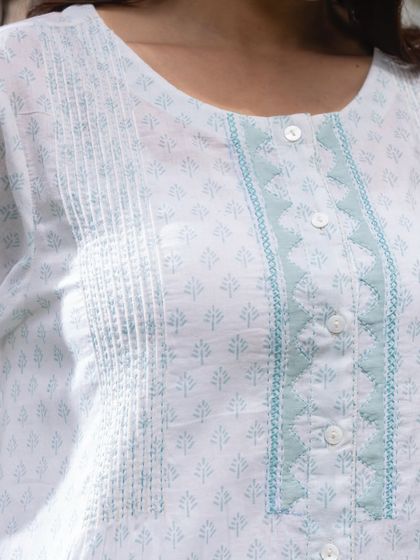 A close-up of the quiet details on our Suhani Appliqué edit. The pintucks and appliqué on the placket are crafted one stitch at a time, creating a piece that feels special and unique.