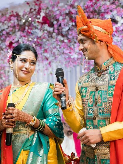 The couple shares a moment on stage during their Maharashtrian Sangeet, a celebration filled with music and joy.