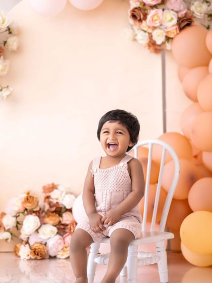 This cutie is turning one! Her happy laugh while sitting on a little chair is just priceless.