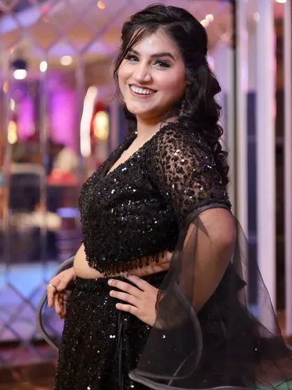 A happy and confident party-goer. Her smile and the glowing makeup light up the photo.