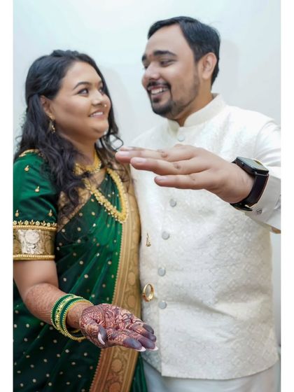 A playful and happy moment right after the ring exchange at an engagement ceremony.