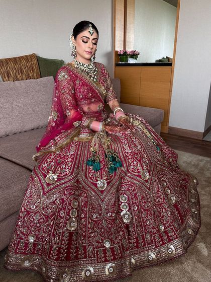 A full-length shot of the bride in her stunning JJ Valaya lehenga, her elegant bun completing the regal look.