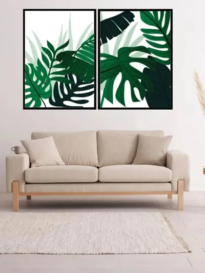 This set of two botanical art prints showcases the bold, graphic shapes of tropical leaves. The deep green colors create a lush, vibrant look that enlivens any living space.