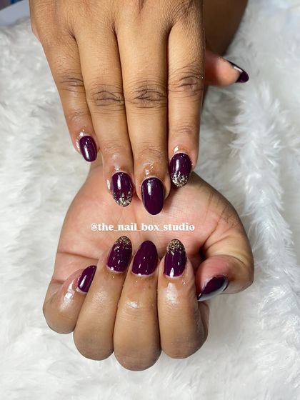 A full view of the plum and gold glitter set. This is a great example of how a little bit of glitter can completely elevate a simple, single-color manicure.