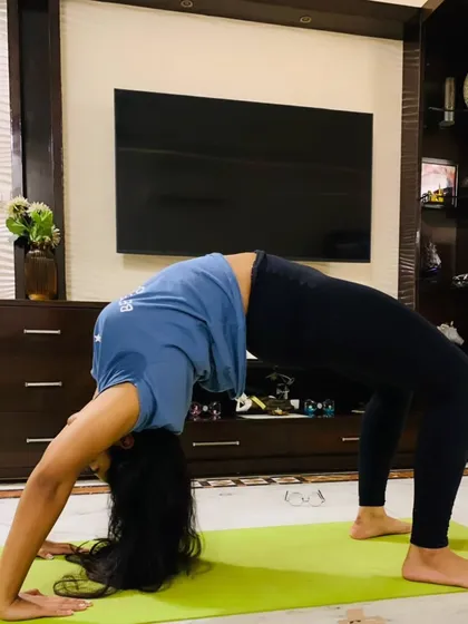The same student demonstrating a strong and open Chakrasana (Wheel Pose), a testament to her improved back flexibility and shoulder strength.