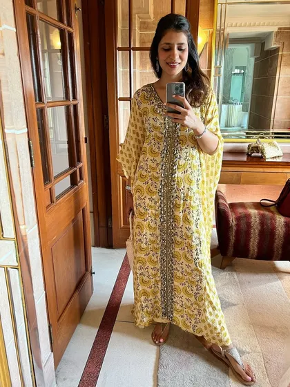 A selfie in a beautiful yellow printed kaftan. Kaftans are my go-to for an effortlessly chic look, whether for a festive occasion at home or on vacation.