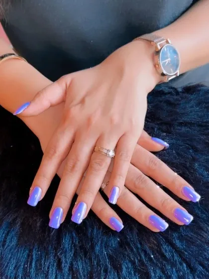 A vibrant and trendy periwinkle blue polish that makes a beautiful statement on these clean, square nails.