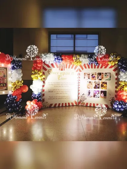 A "Once Upon a Time" storybook-style photo display for the carnival party. The display is framed by a classic red, white, and blue balloon arch.