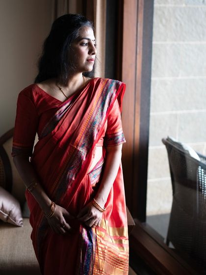 A self-portrait in a beautiful red saree. This image is a reflection on my philosophy that the most powerful stories are found in the simplest moments, observed with the heart.