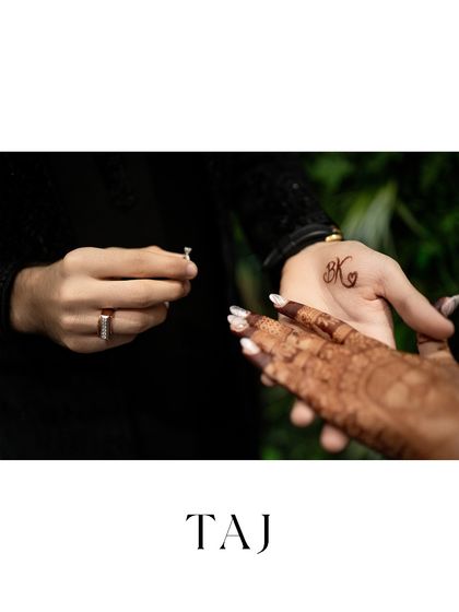 A moment of anticipation just before the ring is placed on her finger. This shot captures the intimacy and significance of the engagement ritual.