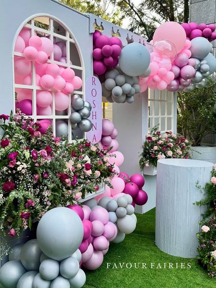 Another angle of this whimsical bridal shower, showing how the balloon and floral arrangements create a sense of depth. The mix of textures and shades of pink and grey made this setup truly stand out.