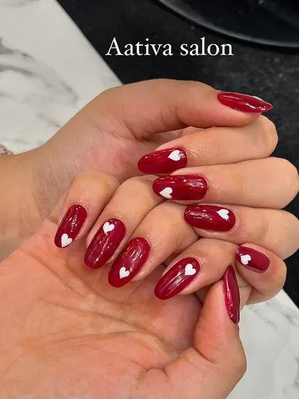 Another example of our heart-themed nail art, showing the glossy finish and perfect almond shape.