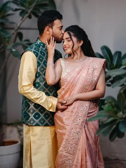A sweet moment between the couple. Her radiant makeup looks beautiful and natural in this candid shot.