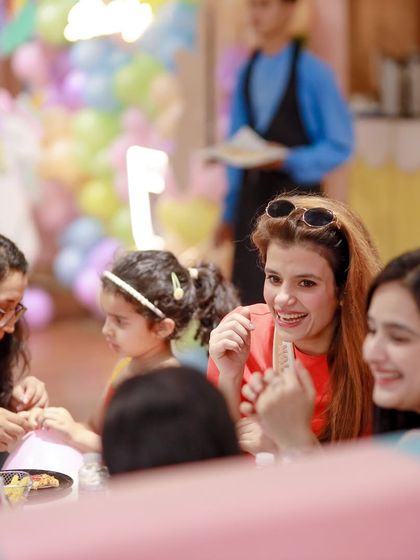 Guests enjoying conversation and food at the party. Our cafe provides a comfortable space for adults to relax and socialize.