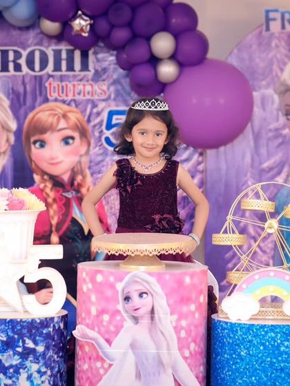 A thrilling 'Dinosaur' themed birthday party, with prehistoric backdrops, dinosaur cutouts, and lush greenery, transporting guests to a Jurassic world.