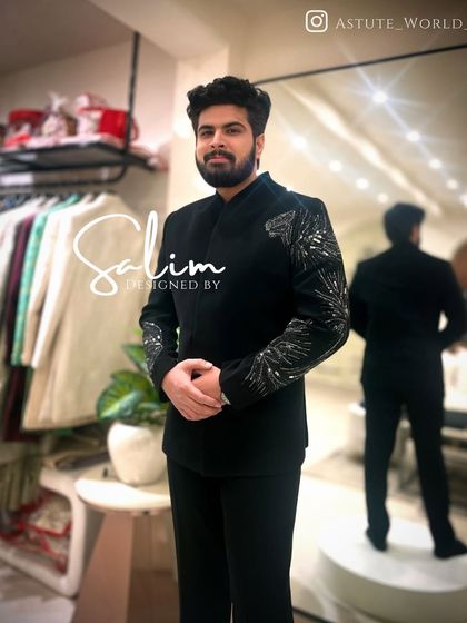 A client in a black Jodhpuri-style jacket with silver embroidered sleeves. This is a great example of blending traditional Indian silhouettes with modern embellishments.