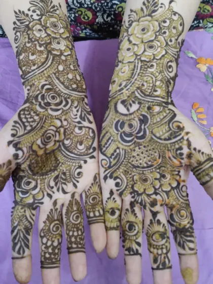 A classic party mehndi design for both hands. The patterns are asymmetrical, giving each hand its own unique personality while still looking like a beautiful pair.