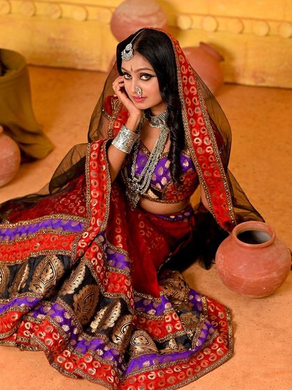 Another angle from our versatile Rajasthani set. The model is seated among the pottery props, creating a grounded and authentic village scene.