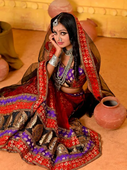 Another angle from our versatile Rajasthani set. The model is seated among the pottery props, creating a grounded and authentic village scene.