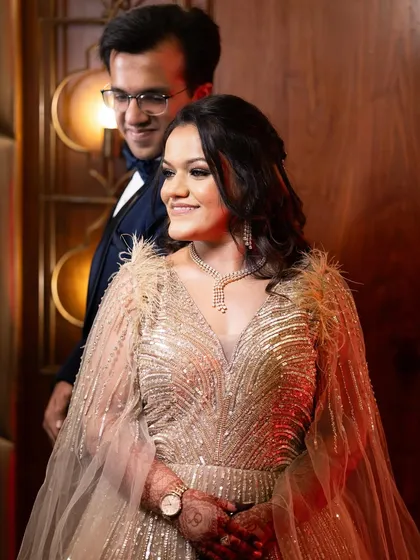 A candid shot of the couple. Her makeup looks beautiful in the warm, ambient lighting.