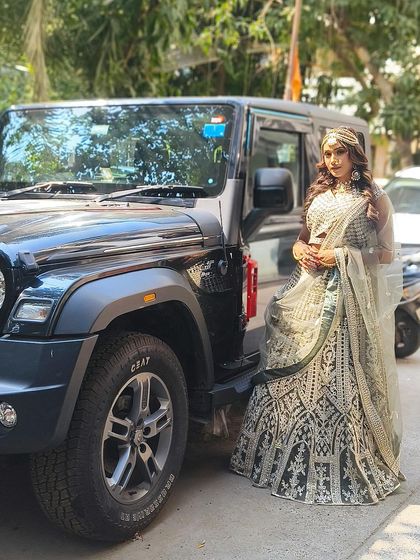 Posing with a Thar in our gorgeous black and silver lehenga. This outfit is all about making a bold and stylish statement.