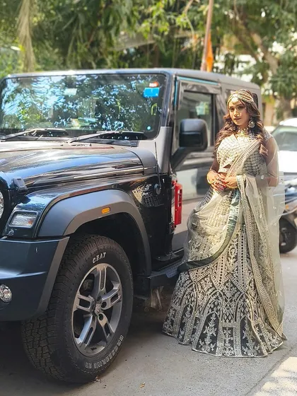 Posing with a Thar in our gorgeous black and silver lehenga. This outfit is all about making a bold and stylish statement.