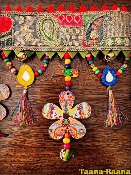 This is a close-up of my 'Taana Baana' toran, where every detail is pure handmade joy. I love combining traditional paisley lace with my own art on wood, colorful beads, and little tassels that dance in the breeze.