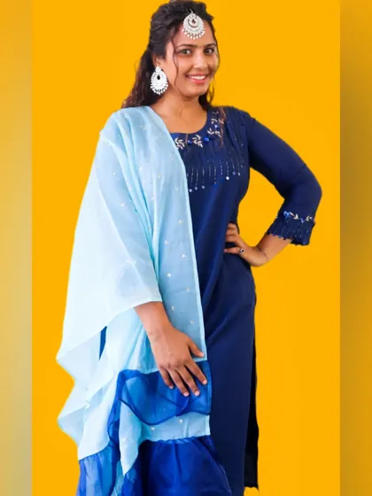 A full look at my festive suit. The combination of dark blue and sky blue is classic and elegant. I sourced the jewelry locally, proving you can create a high-impact look by mixing and matching.