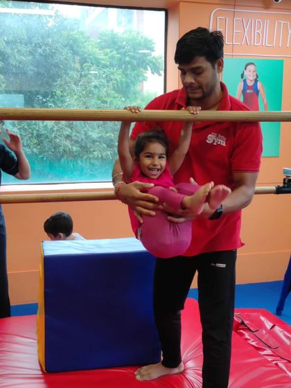 A huge smile from a happy gymnast. Our coaches ensure every child feels safe and celebrated as they try new challenges.