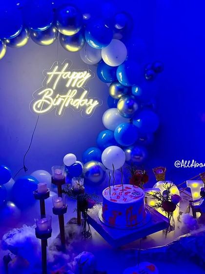 We love creating unique ambiances, like this 'Smokey Lounge' setup. The combination of blue and silver balloons, a custom neon sign, and a dramatic smoke effect creates a cool, moody vibe for a stylish birthday party.
