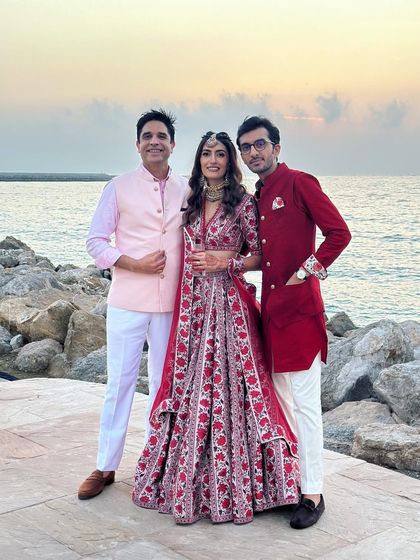 Posing with the beautiful couple against a stunning seaside sunset. Destination weddings create the most picturesque memories.