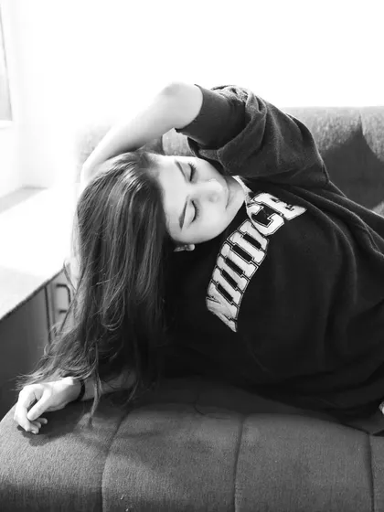 A peaceful, eyes-closed moment captured in black and white. This shot has a very serene and gentle quality.