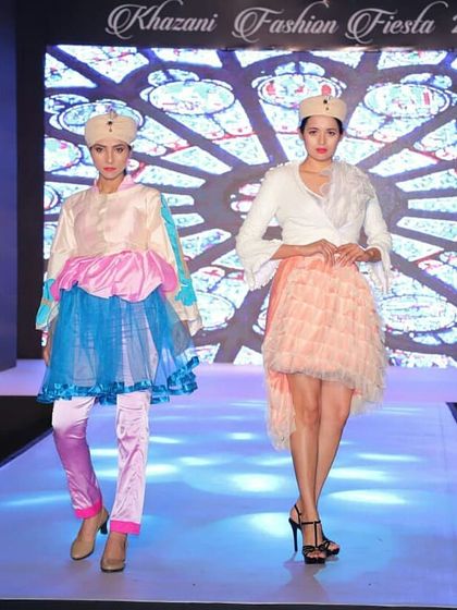 Color and texture play a key role in these student designs. The outfits feature layered tulle skirts, satin pants, and structured tops, demonstrating advanced garment construction skills taught in our diploma courses.